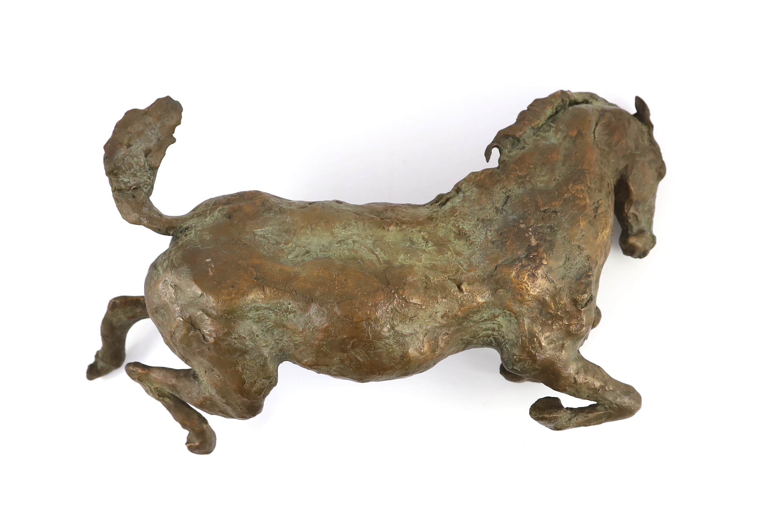 Lissa Borkowski (b.1949). A bronze model of a recumbent foal, 54cm long, 28cm deep, 22cm high